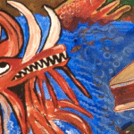 the head of the knucker dragon, bright red with sharp teeth and horns