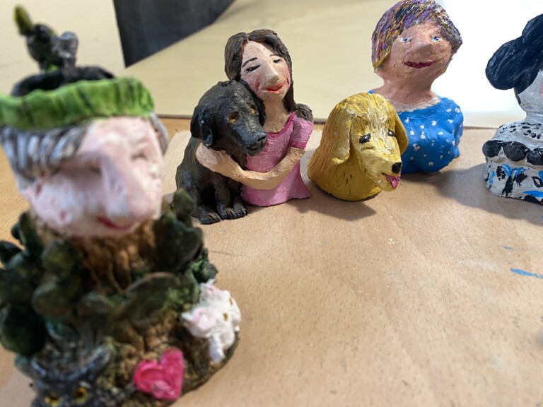 a group of clay figures, brightly painted