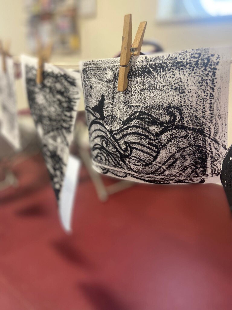 Some Lino cut prints hanging on a washing line