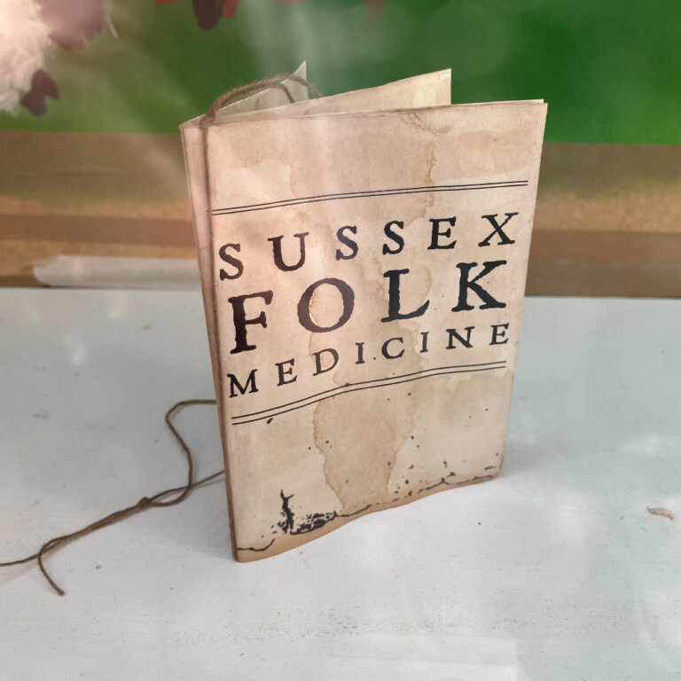 a small paper booklet, the cover reads 'Sussex Folk Medicine'