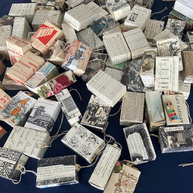 dozens of small boxes, some piled on top of each other. The boxes are covered in images and writing