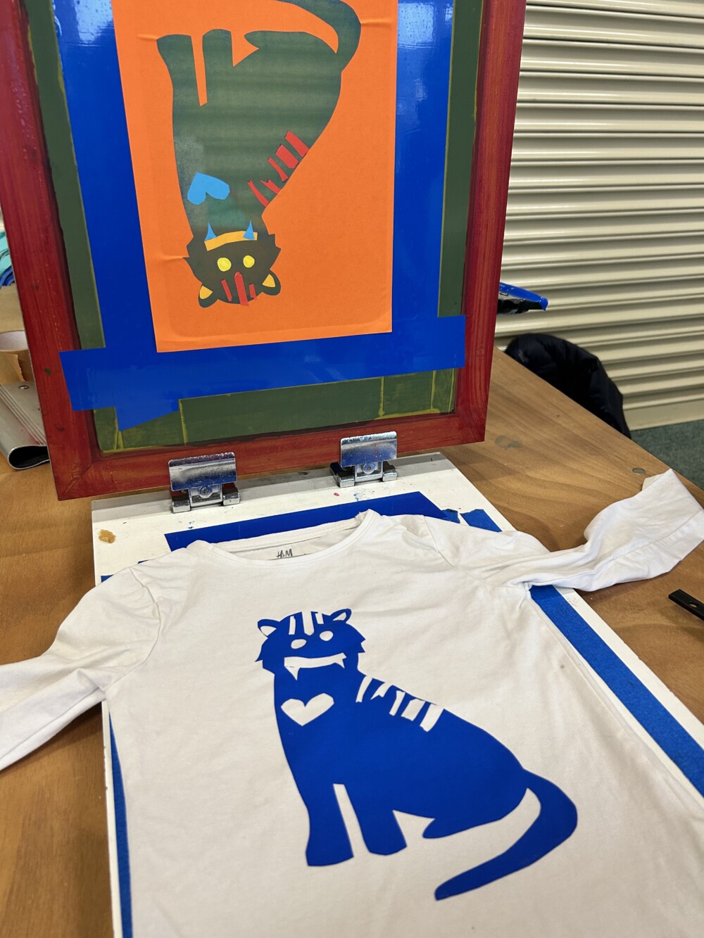 a screen print of a tiger on a white t-shirt