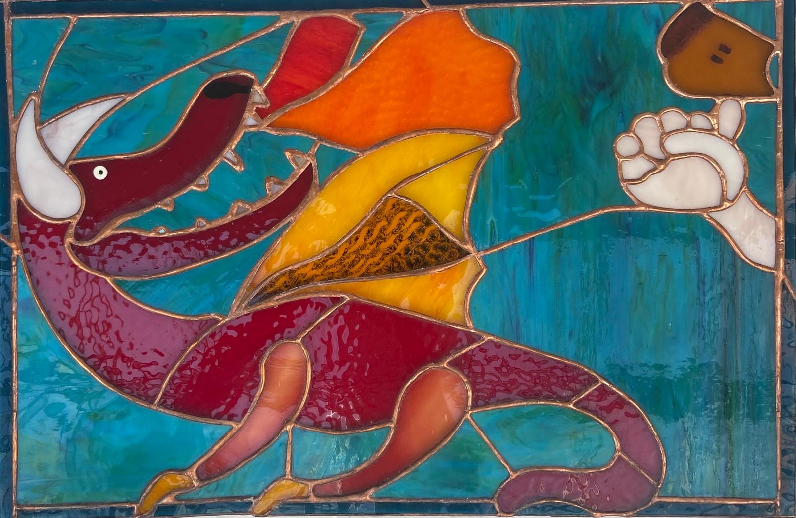 a stained glass depiction of the Sussex Knucker, a fearsome dragon breathing fire