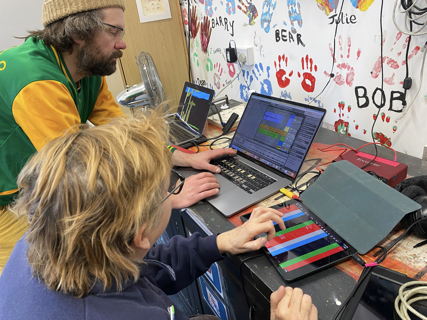 Sam Dook from Lifesize CIC and Debbie from Figment Arts are working on a laptop and an iPad