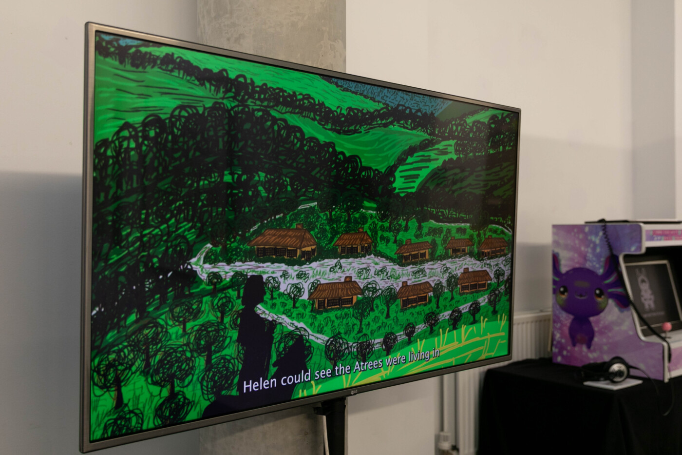 a large TV screen showing an animated scene of a Sussex downland village from the Devil's Dyke story