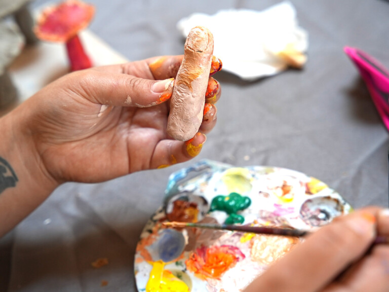 we see someone's hand, holding a life like sculpture of a single finger. They are painting the finger in realistic tones.